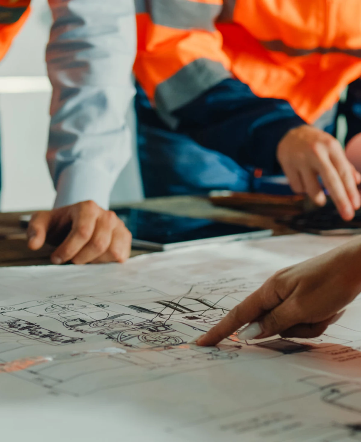 Team reviewing building blueprints
