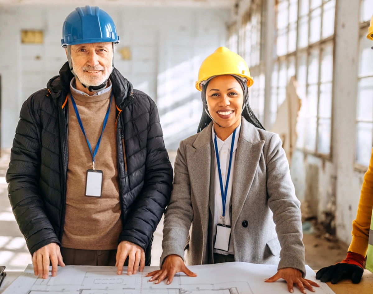 Engineers wearing safety helmets indoors